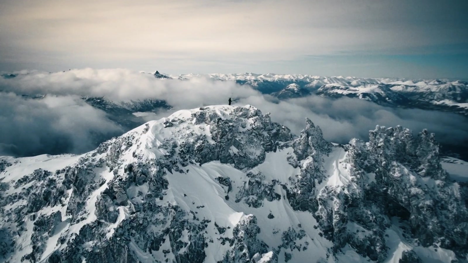 Aerial of alpine peaks above the clouds