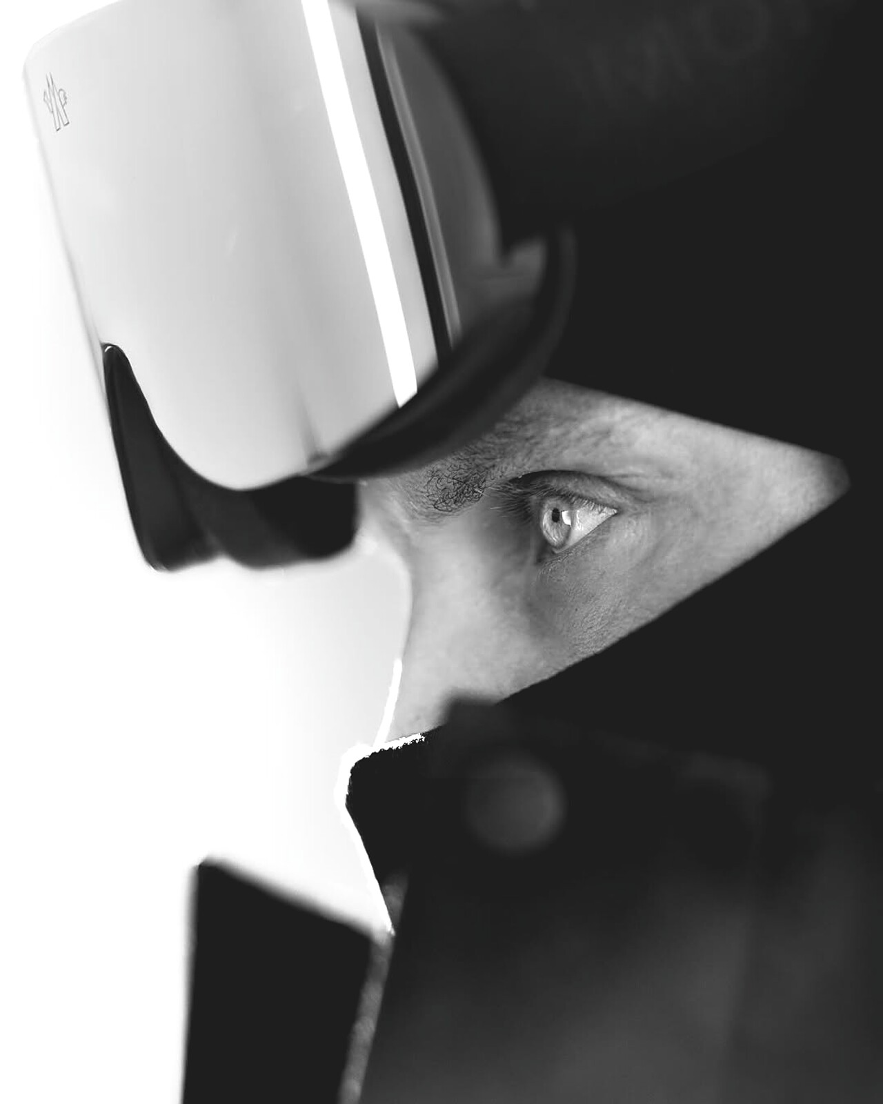 High-key profile portrait of Richard Permin in Moncler goggles